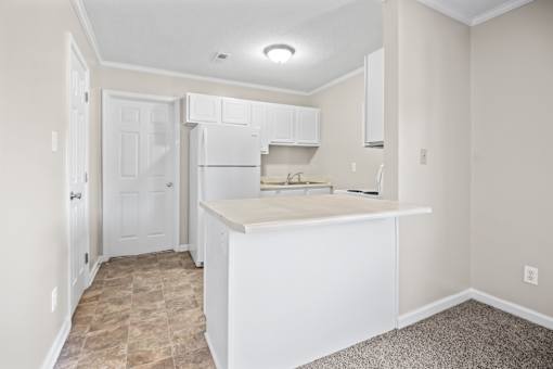 A kitchen with white cabinets and a countertop.