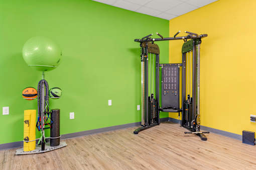 A gym with a green wall and a yellow wall.