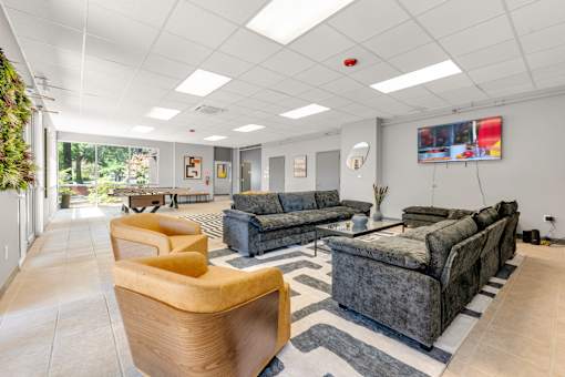 A living room with a grey couch and a yellow chair.
