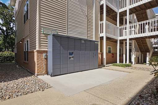A modern building with a garage door and a balcony.