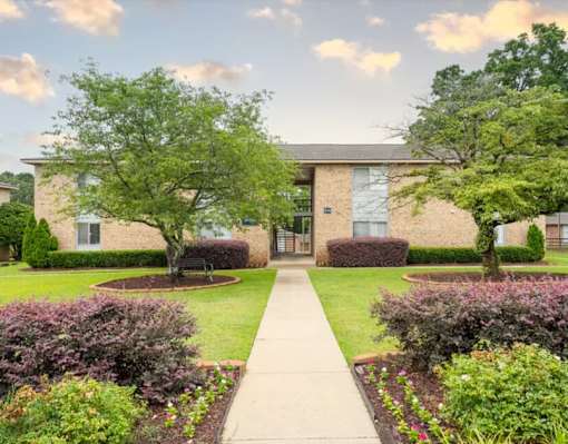 A building with a green lawn in front of it.