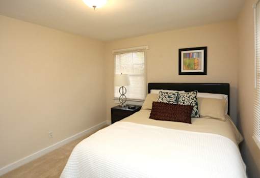 View of bedroom model with bed and nightstand