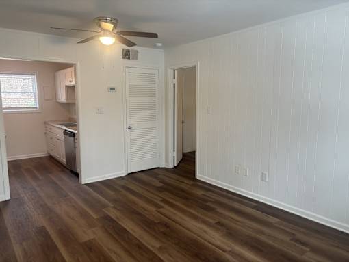 A room with wooden floors and white walls.