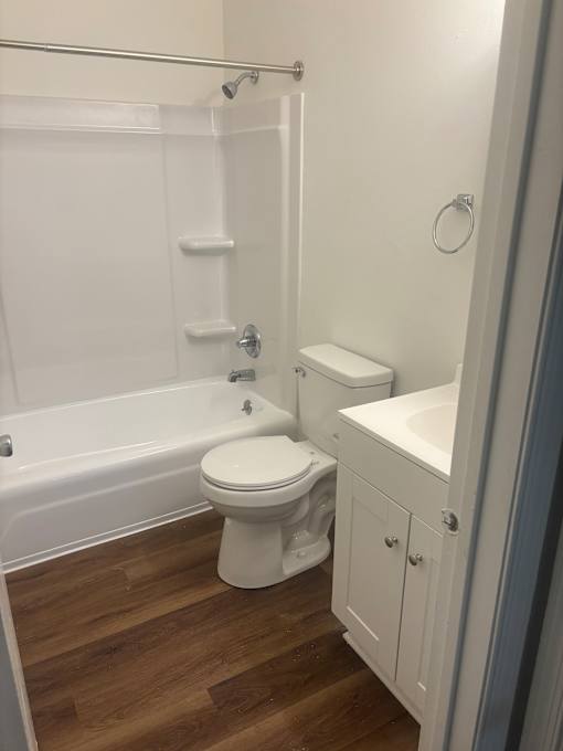 A white bathroom with a toilet and a shower.