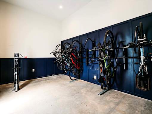 A bike rack with several bikes hanging on it.