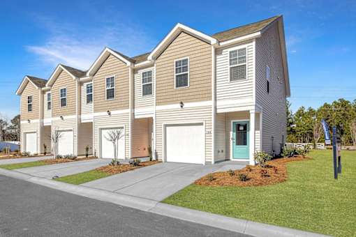A row of houses with a clear blue sky above them.