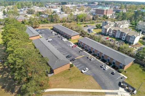 A parking lot is in front of a building.