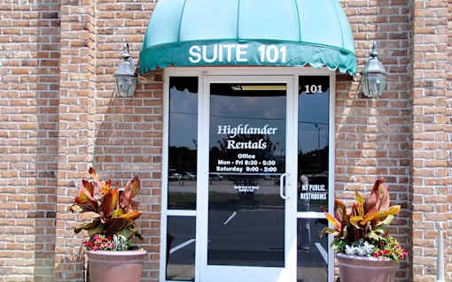 A building with a green awning and a sign that says "SUITE 101".