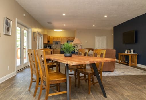 A dining room with a wooden table and chairs.