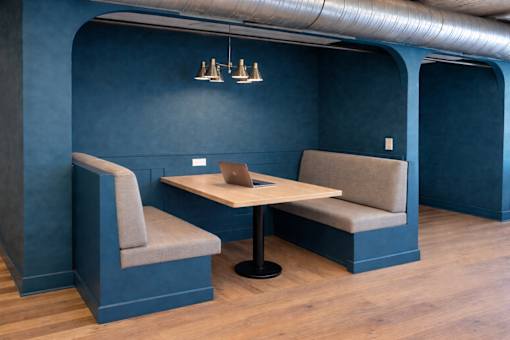 A blue room with a table and two chairs.
