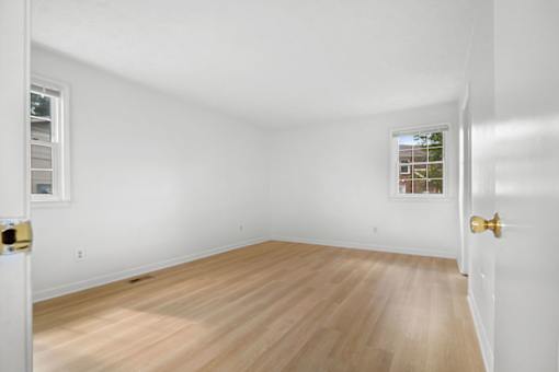 A room with a wooden floor and white walls.