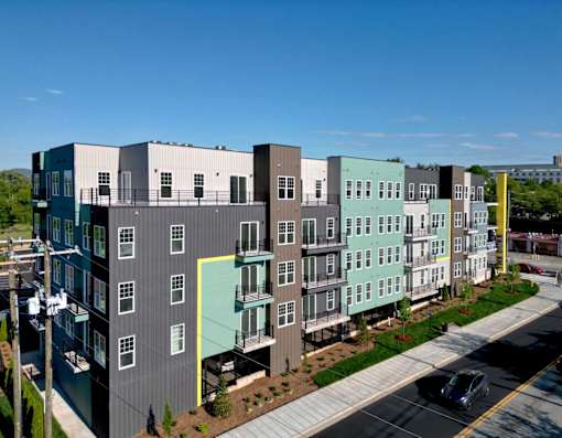 A street view of a row of modern apartment buildings.