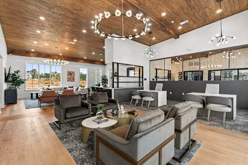 A modern living room with a wooden ceiling and a variety of seating options.