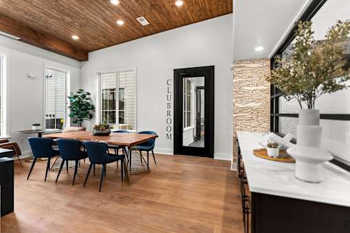 A dining room with a wooden table and chairs.