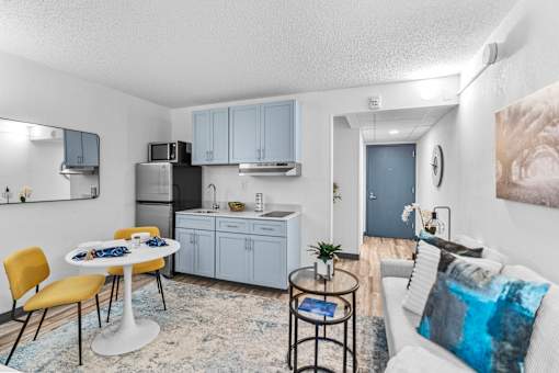 A modern kitchen with a dining table and chairs.