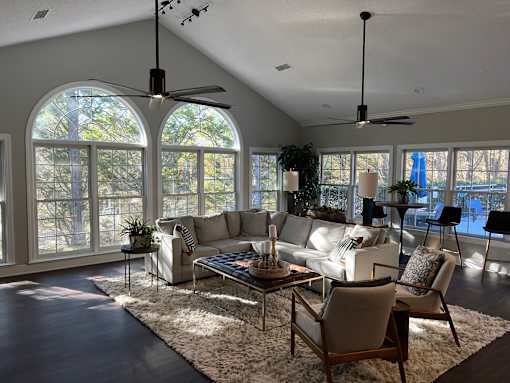 A living room with a white couch, a coffee table, and a rug.
