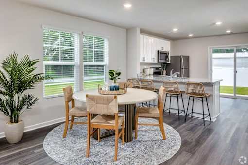 A dining room with a table set for six.