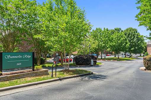 A street view of Summerlin Ridge with a green signboard.