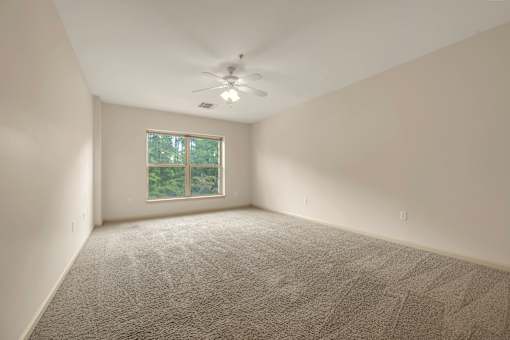 A room with a carpet floor and a window.