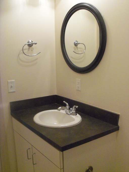 A bathroom with a sink and a mirror.