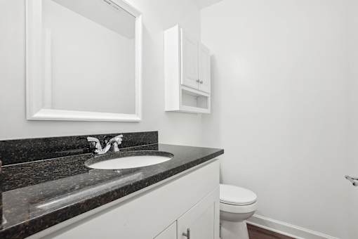 A bathroom with a sink, toilet and medicine cabinet.