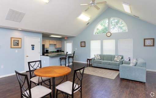 A living room with a dining table and chairs.