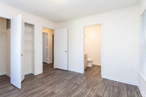 A room with a toilet and a door on the right.