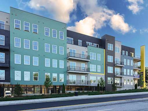 A modern apartment building with balconies and multiple stories.
