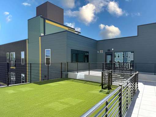 A modern building with a green lawn in front.