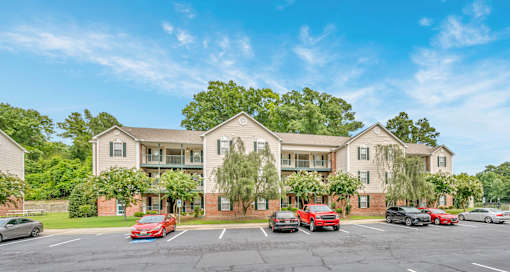A large building with a parking lot in front of it.