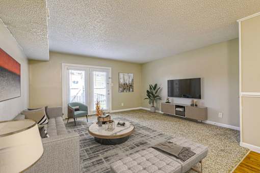 A living room with a grey couch and a coffee table.
