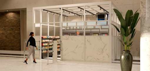 A woman in a black top and grey pants is walking past a bookshelf in a modern interior.