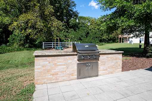 A brick wall with a grill on top.