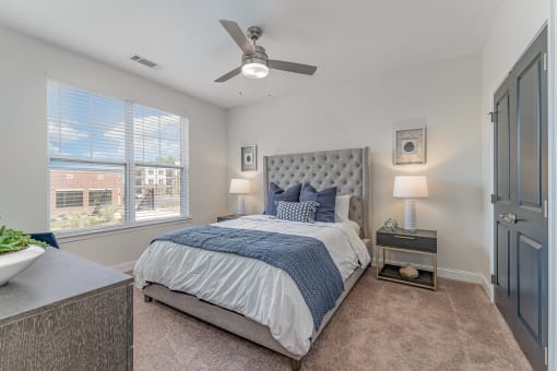 a bedroom with a bed and two windows