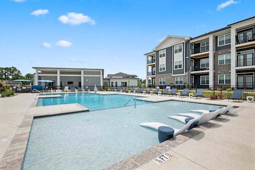 A swimming pool with a building in the background.