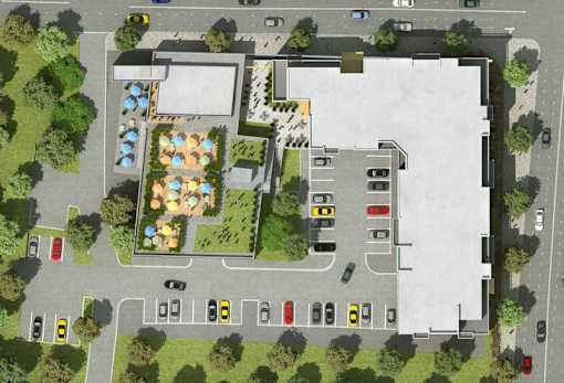 A top-down view of a parking lot with cars and a building.