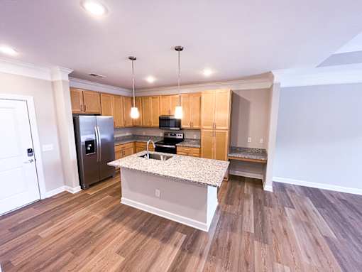 A kitchen with a granite countertop and stainless steel appliances.