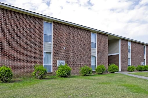 A brick building with a sign on the front.