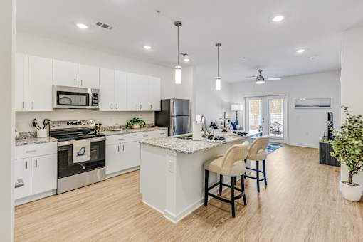 A modern kitchen with white cabinets and a center island.