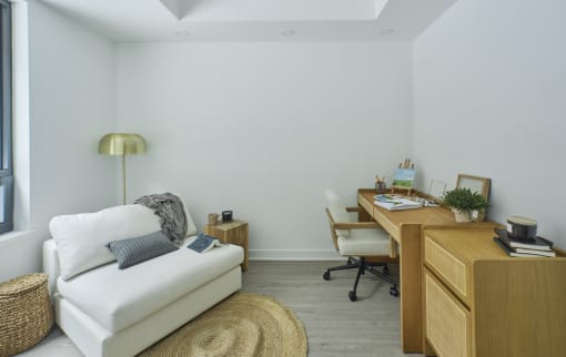 a living room with a couch and a desk