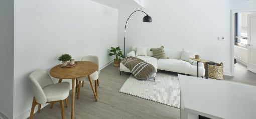 a living room with a white couch and a wooden table