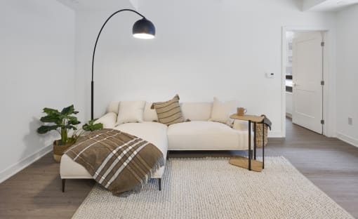 a living room with a couch and a lamp