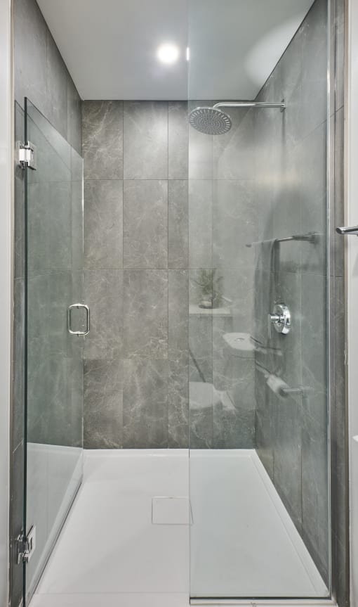a shower with a glass door in a bathroom