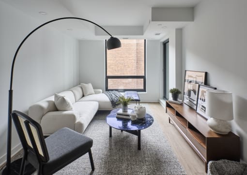 a living room with a white couch and a coffee table