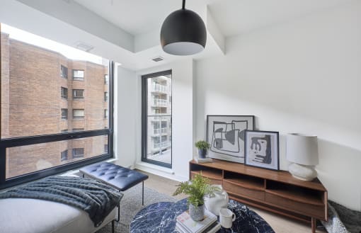 a bedroom with a bed and a large window