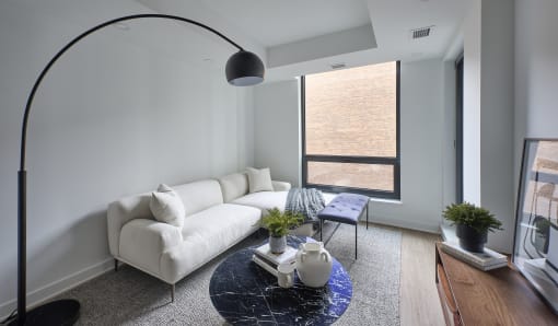 a living room with a white couch and a blue table