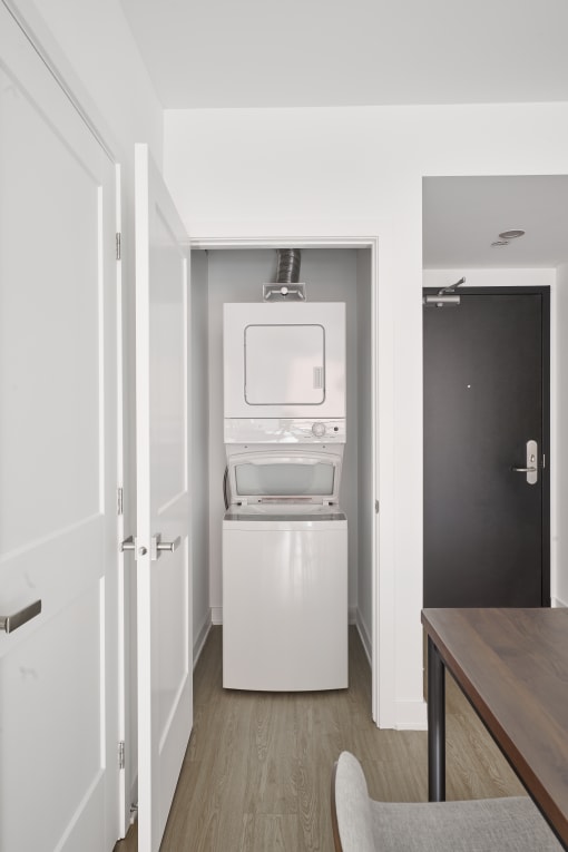 a small room with a refrigerator and a washing machine in it