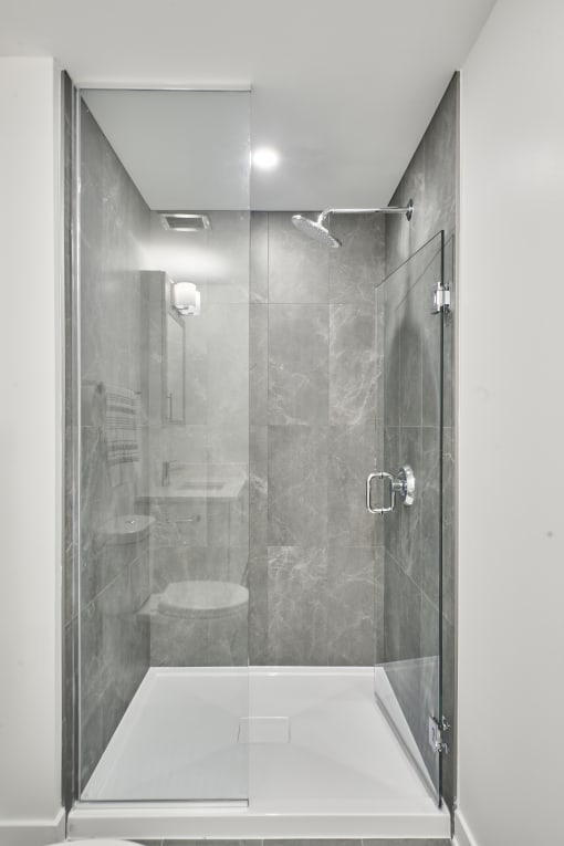 a shower with a glass door in a bathroom