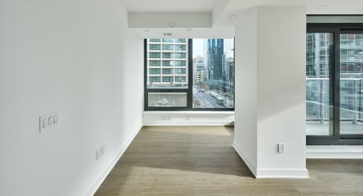 a living room with a large window and a view of the city