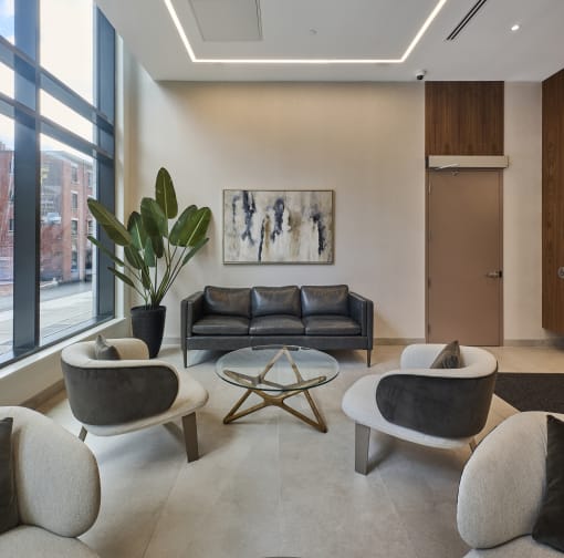 a living room with a couch and chairs and a table
